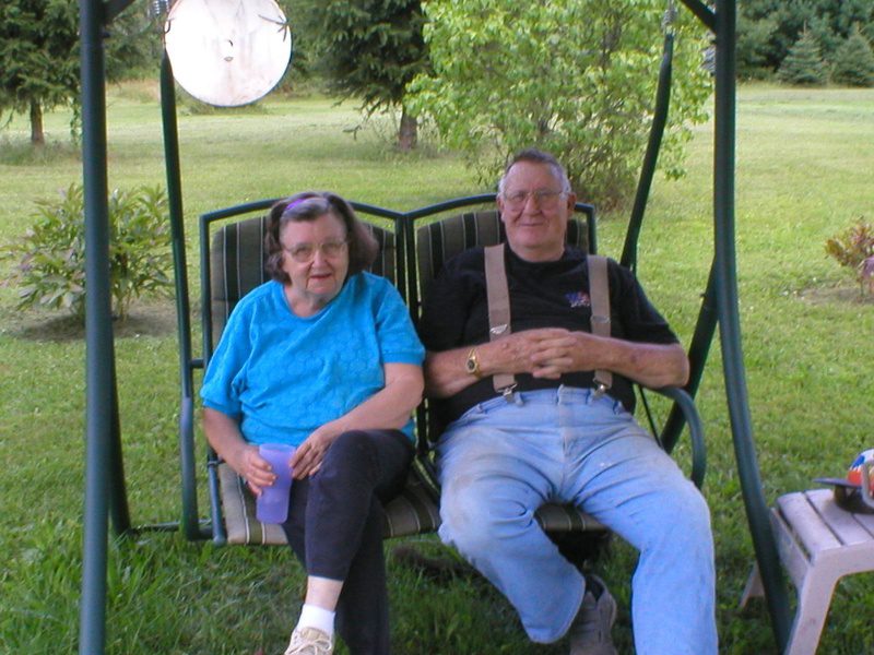 The E & S family sitting on a swing.